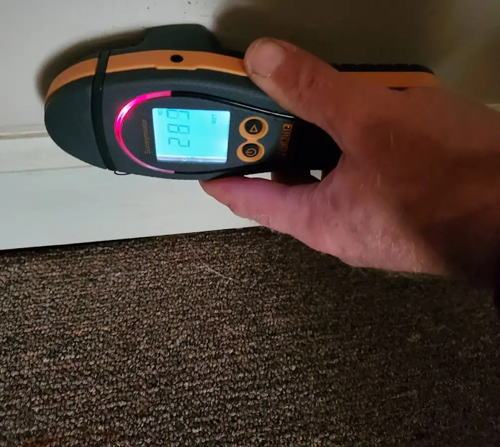 Moisture detection at baseboard during Storm Damage Restoration in Greenwood